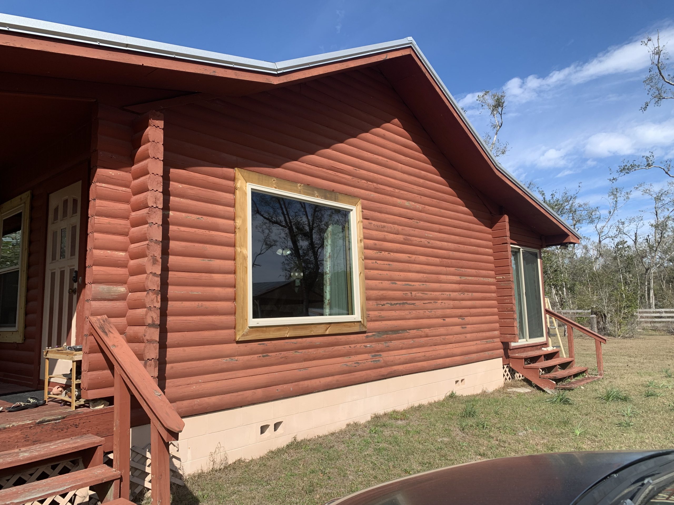03-log-cabin-restoration-live-oak-fl-porch-entry-before Before restoration: porch entry of a log cabin with peeling stain in Live Oak, FL