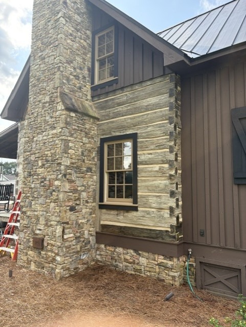 Restored hand-hewn log wall and dovetail corner on a historic log home