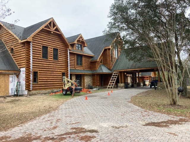 End seal application in progress on a large log home during restoration