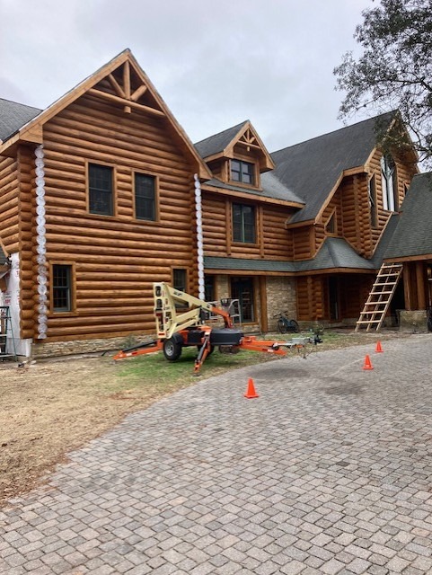 End seal applied to exposed log ends on a large log home, drying clear