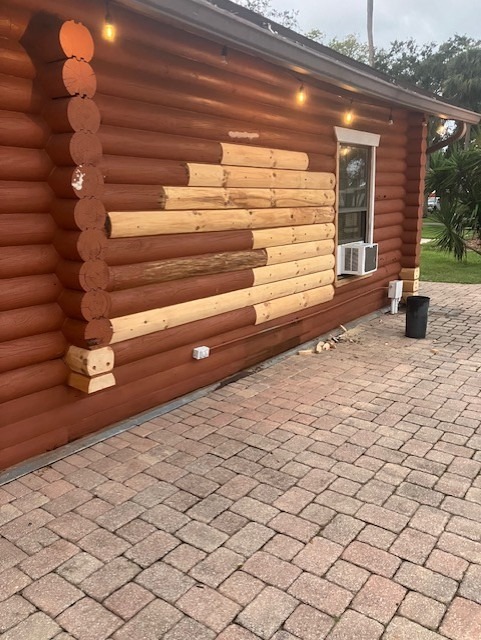 New logs spliced into a stained log wall where damaged sections were removed