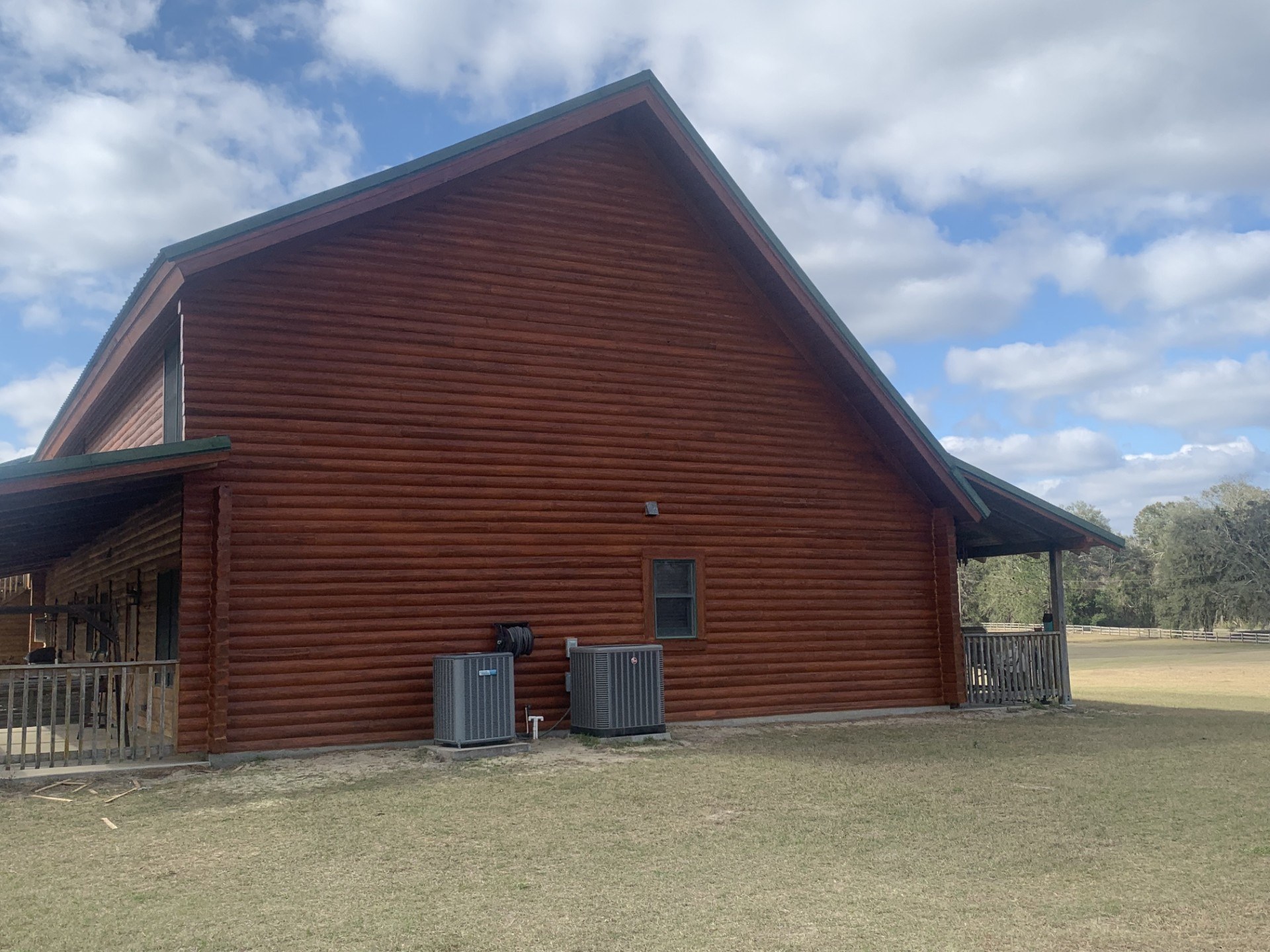 Log home gable finished in a deep brown stain