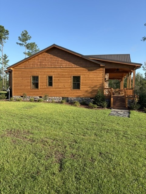 Log home side elevation finished in a warm honey-toned stain