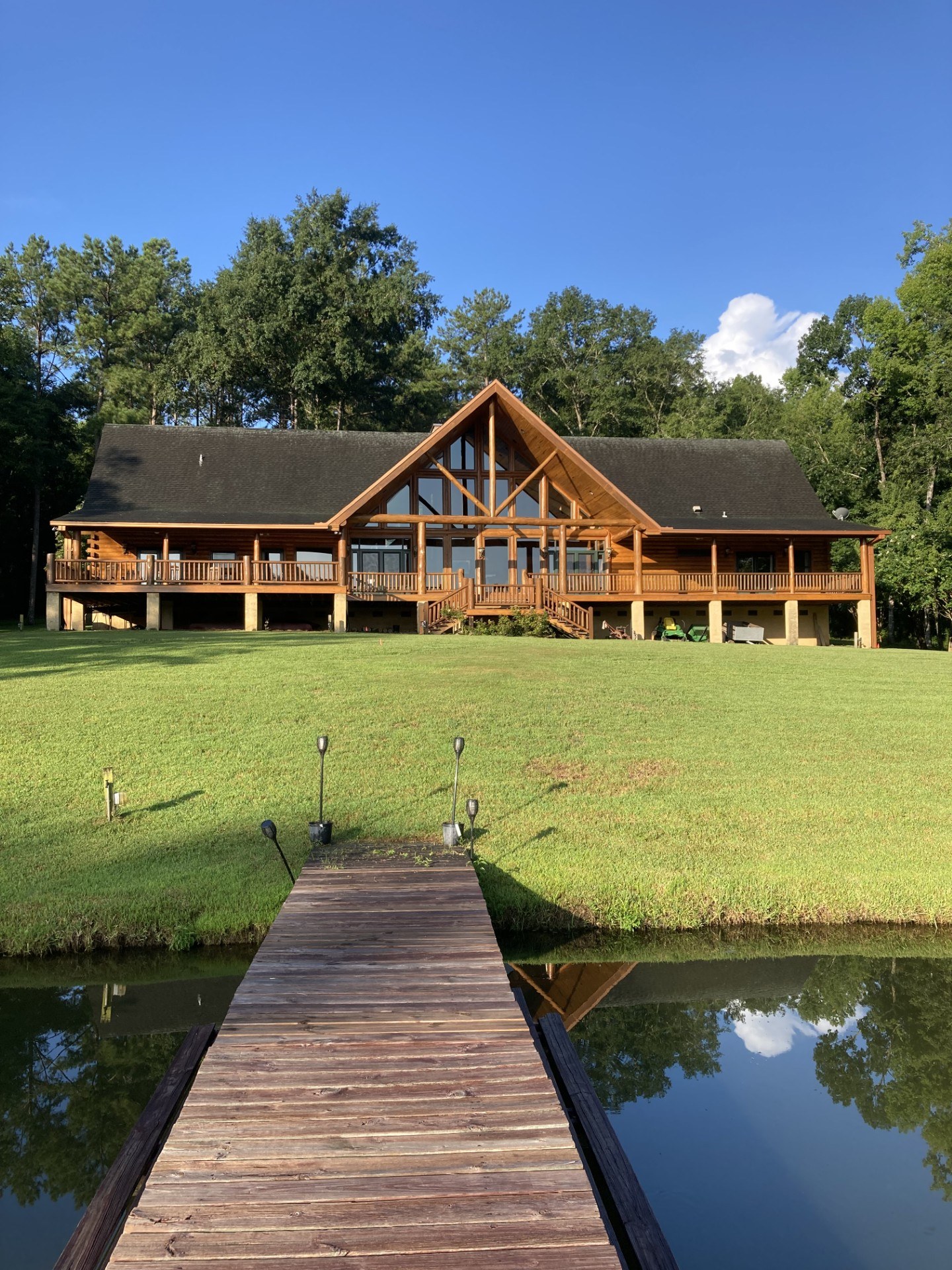 Restored log home seen from the dock across its pond