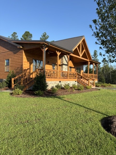 Restored log home with a covered porch in evening light