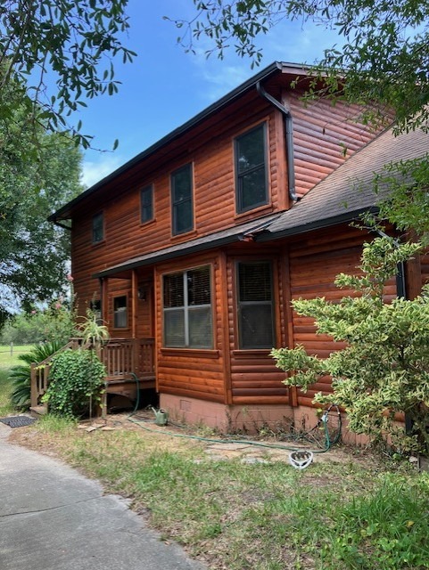 Side elevation of a restored two-story log home